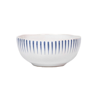 The Juliska Sitio Stripe Dinnerware features a white ceramic bowl with a gently wavy rim and evenly spaced vertical Delft blue lines, finished in a crisp whitewash glaze.