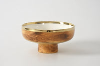 Introducing the Madera Footed Bowl by PAMPA BAY—a modern and elegant decorative bowl featuring a wood-grain pattern, a lustrous gold rim, and a pedestal base. Its white interior contrasts beautifully against the plain white background, making it a stylish addition to any décor.