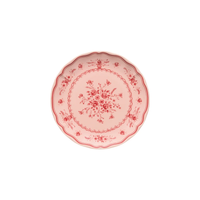 Vila Pink / Red Dessert Plate in pink stoneware with a scalloped edge and red floral patterns.