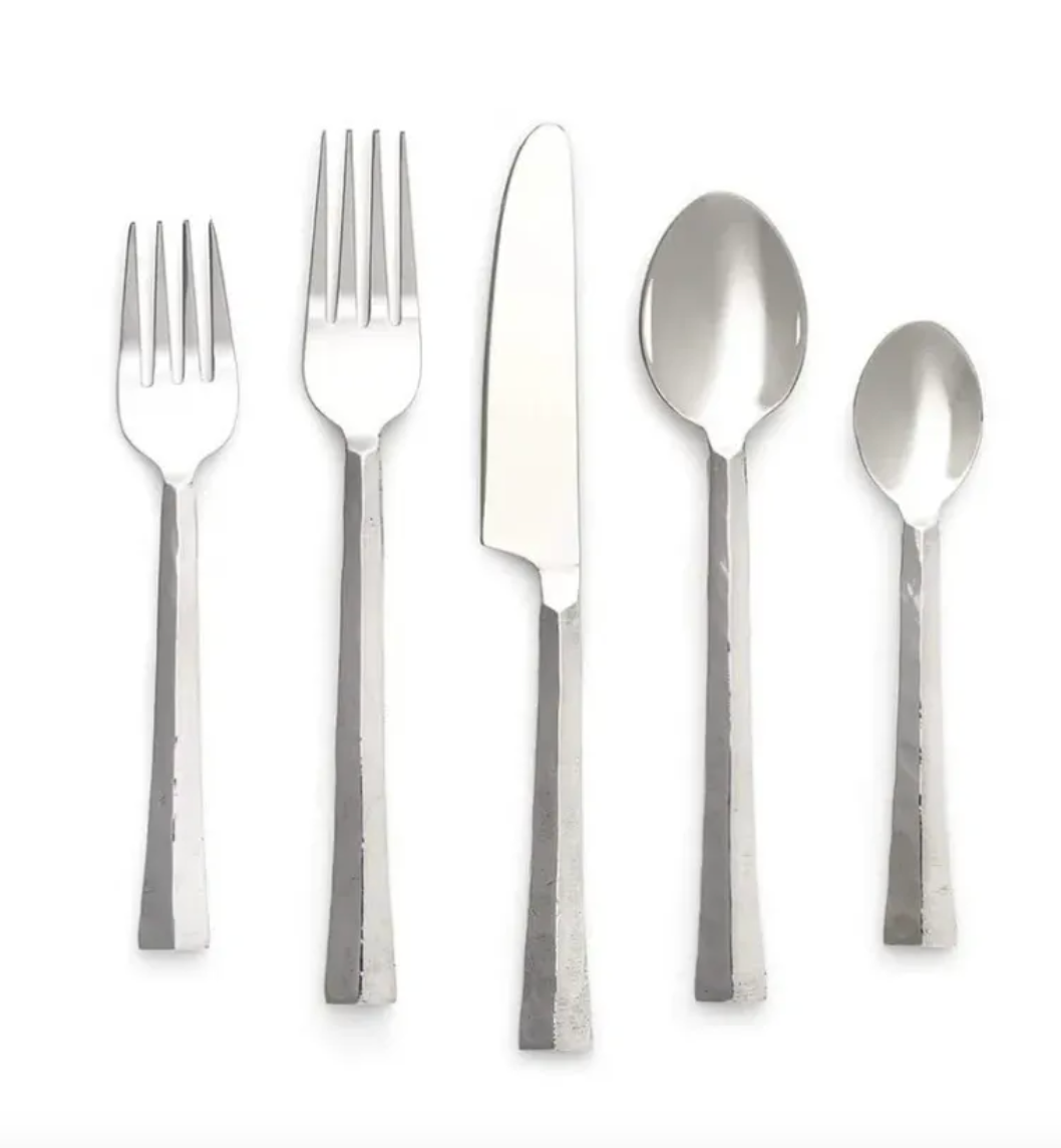 Set of silver cutlery including forks, knife, and spoons on a white background
