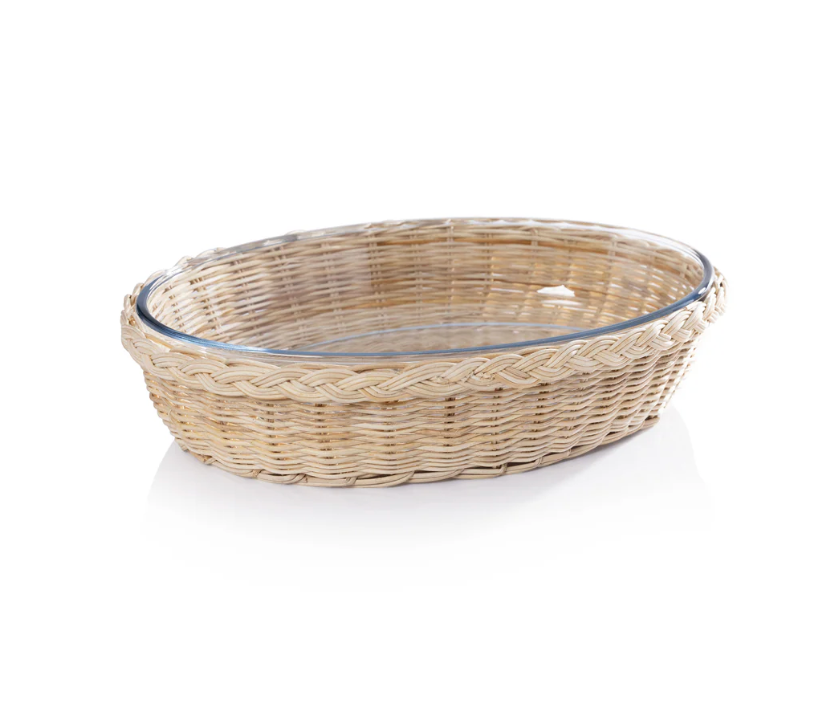 A round, shallow Palmetto Oval Baker by Zodax, featuring a wicker basket with a glass insert, shown on a white background.
