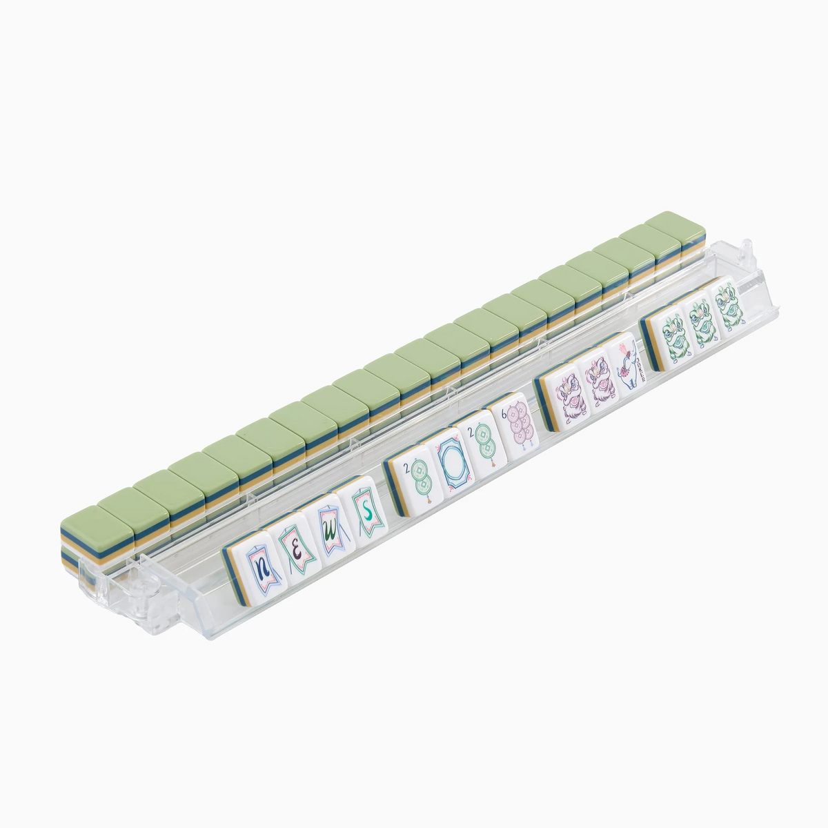 A transparent Mahjong tile rack displays green-backed tiles, with several face-up tiles at the front showing various symbols and letters spelling “news.” The elegant Oh My Mahjong brand’s Willow Mahjong Tiles Set adds a refined touch to your game night.