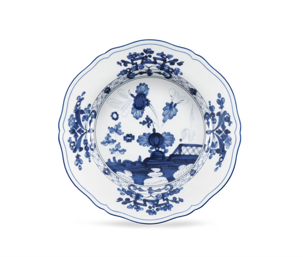 Ginori 1735 Oriente Italiano Indaco white porcelain bowl with a scalloped edge, decorated with an Antico Doccia blue floral and landscape motif.