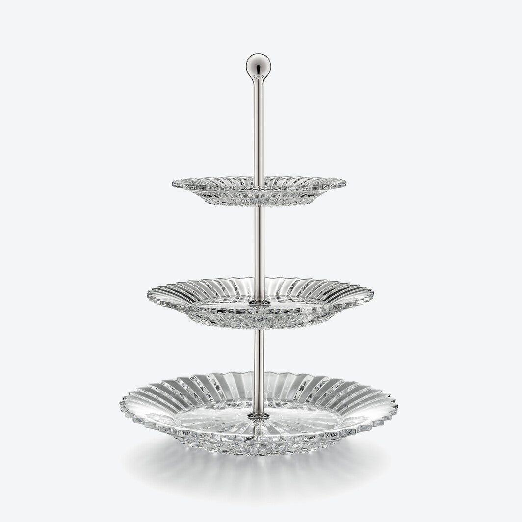 The Mille Nuit Pastry Stand by Baccarat is a three-tiered stand with decorative crystal scalloped plates on a central metal rod, displayed against a plain white background.