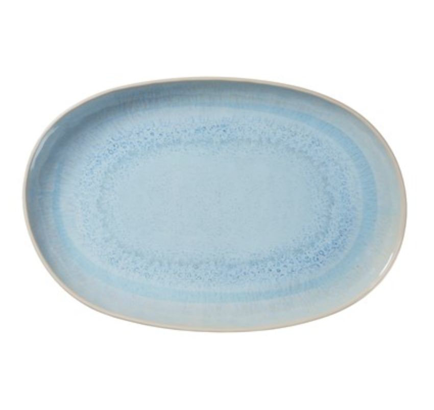 The Merritt Reactive Glaze Melamine Blue Oval Serving Tray 17.25" features a light blue, stoneware-inspired finish with a speckled rim—perfect for elegant indoor dining or stylish outdoor entertaining.
