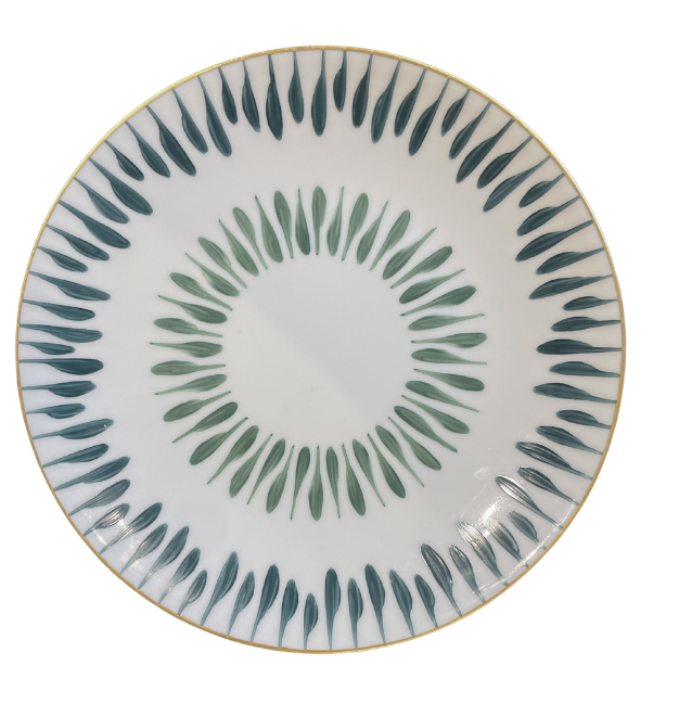 The Marie Daâge Allee de Cypres 5 by Marie Daâge is a round white plate with a gold rim and green and teal leaf designs in concentric circles, showcasing luxury tableware.