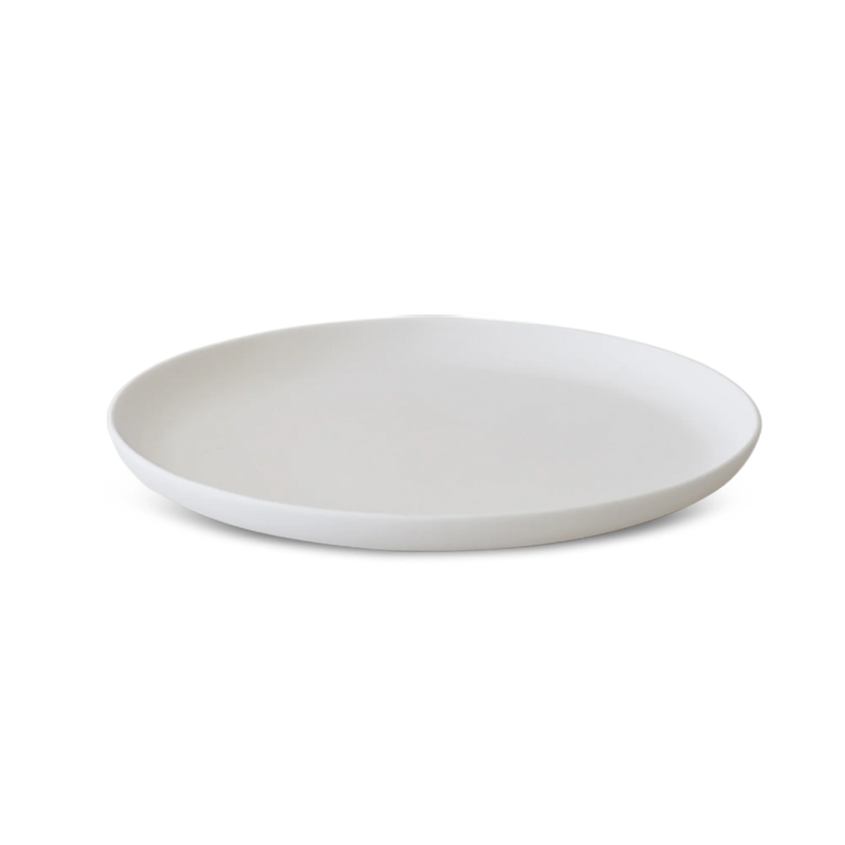 The Modern Round Platter - Lg by Tina Frey is a white ceramic plate with a slightly raised edge, showcased on a white background.