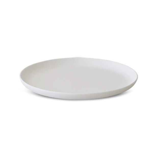 The Modern Round Platter - Lg by Tina Frey is a white ceramic plate with a slightly raised edge, showcased on a white background.