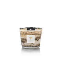 The Baobab Sand Siloli Candle is a hand-blown glass candle with swirling brown, cream, and beige patterns, labeled on the front and topped with a black ribbon. This scented candle is shown against a white background.