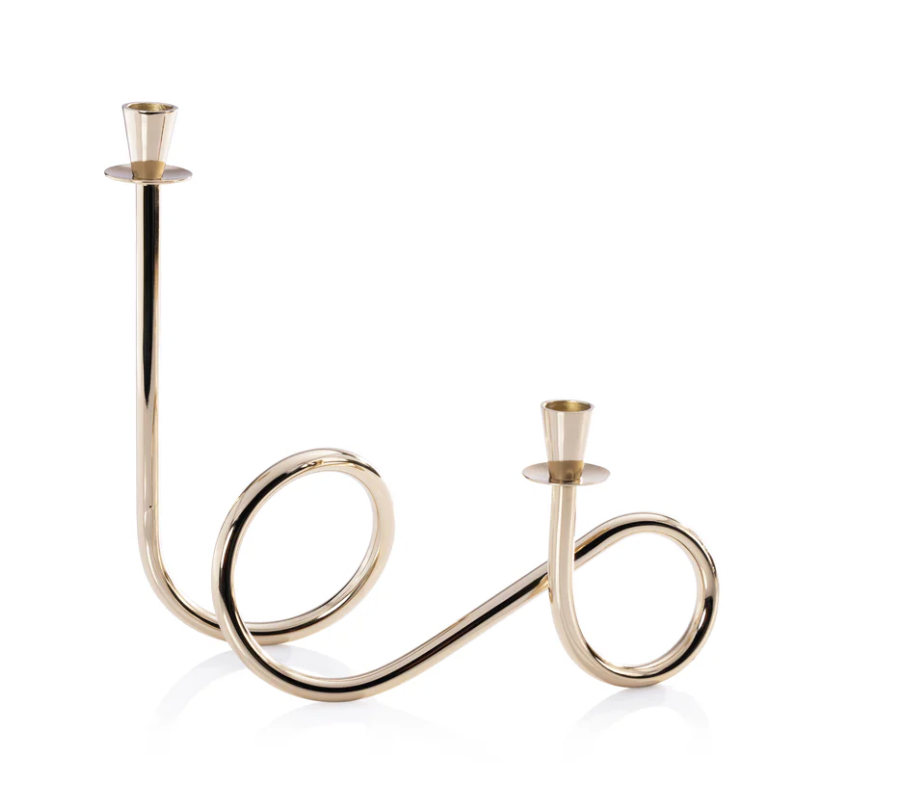 The Braxton Twist Candle Holder - Gold by Zodax features two curved arms, each holding a candle. Set against a white background, this elegant modern design adds contemporary style to any space.