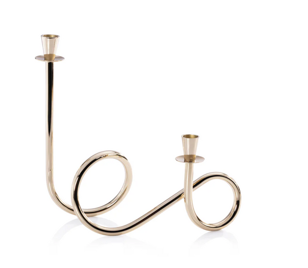 The Braxton Twist Candle Holder - Gold by Zodax features two curved arms, each holding a candle. Set against a white background, this elegant modern design adds contemporary style to any space.