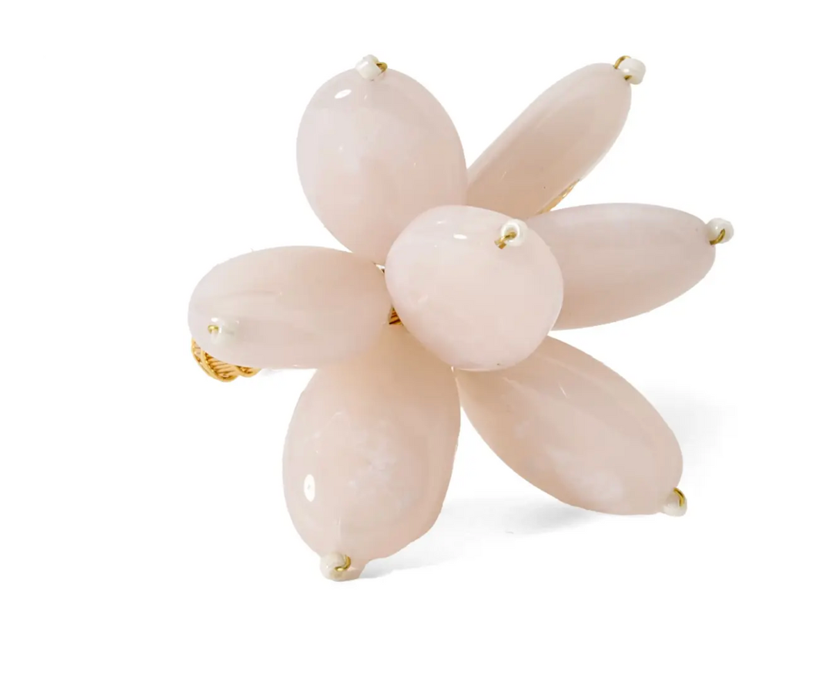 The Mod Stone Flower Napkin Ring Set of 4 by Deborah Rhodes features pale pink teardrop-shaped beads arranged like a flower, reminiscent of modern beaded rings, and is displayed on a white background.