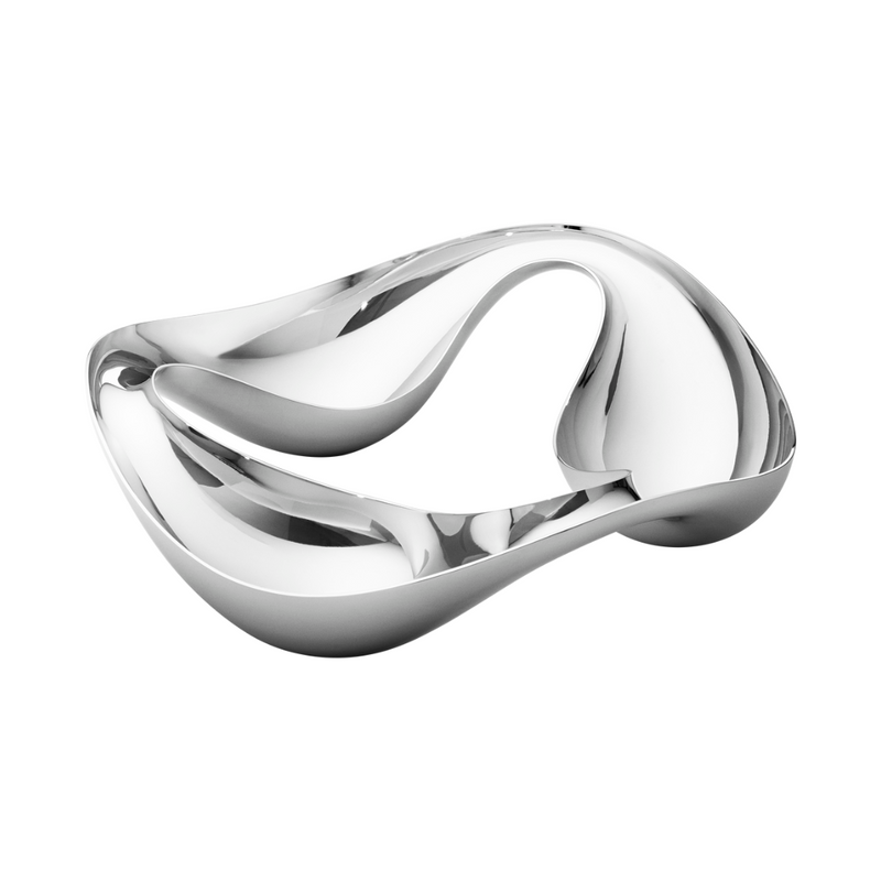 The Georg Jensen Cobra Snack Bowl features a shiny, abstract stainless steel design with smooth curves and an open, sculptural shape—making it a striking centerpiece against a white background.