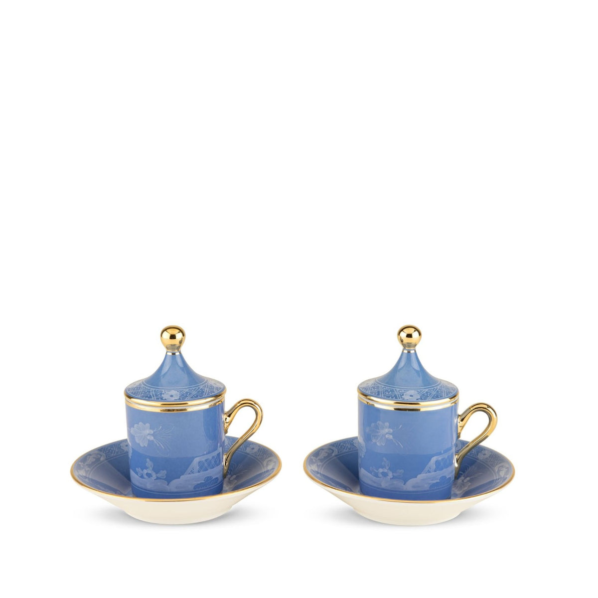 Two light blue Oriente Italiano Pervinca porcelain coffee cups with lids and matching saucers, featuring 24-karat gold trim and white Ginori floral patterns.