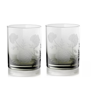 The Current Home Peony DOF Set of 2 features clear, mouth-blown glass tumblers with an etched rose and leaf design—elegant glassware perfect for any refined table setting.
