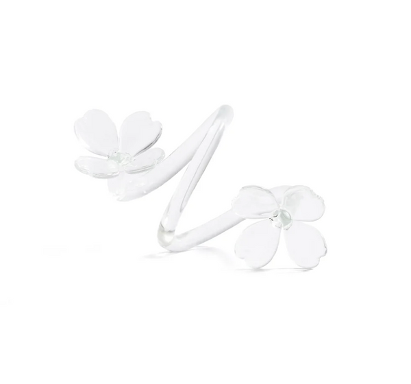 A silver ring featuring two delicate white flower designs at each end, with five petals on each flower, set against a plain white background—perfect for those who appreciate decorative tableware that brings an elegant touch to any setting.