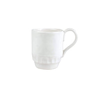 White ceramic Vietri Pietra Serena mug with a textured base and a curved handle.