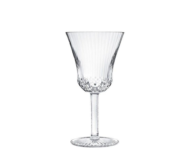 The Apollo Stemware by Saint-Louis/Hermes features a fluted bowl, textured stem, and decorative base. This mouthblown, hand-cut crystal wine glass is elegantly displayed on a white background.