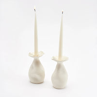 Helen candleholder set displayed her with white taper candles. 