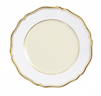 The Mazurka Gold & Ivory by Raynaud is a round, white Limoges porcelain plate with scalloped edges and gold trim, viewed from above against a white background, showcasing exquisite French craftsmanship.