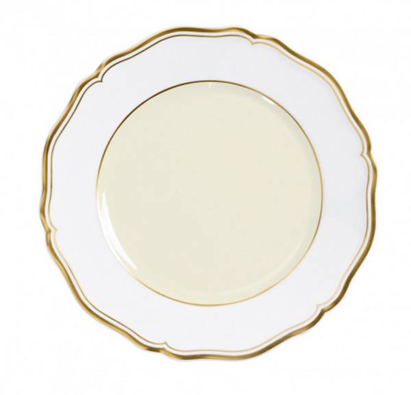 The Mazurka Gold & Ivory by Raynaud is a round, white Limoges porcelain plate with scalloped edges and gold trim, viewed from above against a white background, showcasing exquisite French craftsmanship.