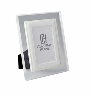 The Prisma Frame Lip - Eggshell by Bella Moulding is a white and silver freestanding acrylic photo frame with a black stand, offering modern protection and elegant display for your 5x7 photos.