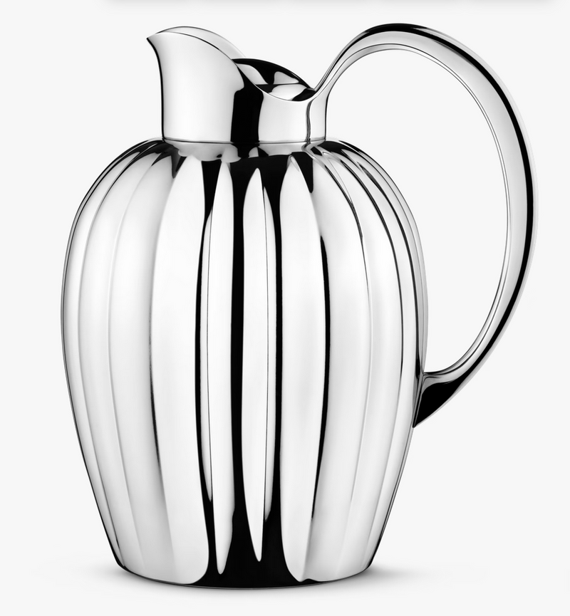 The Bernadotte New Thermo Jug w/Push Stopper for coffee and tea by Georg Jensen features a polished silver fluted design with a curved handle, combining elegance and modern Scandinavian style.