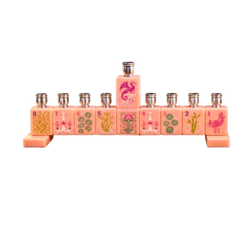 Eclectic Judaica Mah Jong Menorah - Pink Blush featuring nine candle holders shaped like mah jong tiles, each decorated with symbols and numbers.