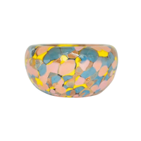 Introducing the Jelly Baby Bubble Bowl ring by Maria Ida Designs—a round, chunky piece with a glossy finish, showcasing an abstract pattern of yellow, blue, and pink patches reminiscent of the vibrant artistry found in blown glass bowls and art glass creations.