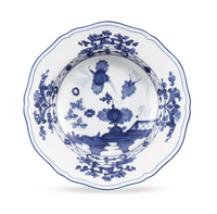Ginori 1735 Oriente Italiano Indaco scalloped porcelain bowl featuring a blue floral and landscape pattern on a white background.
