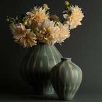 Two Jace Vases from FlowDecor Inc.—one large and one small—feature elegant ceramic construction with green and beige patterns. The larger decorative vase displays a bouquet of pale, full-bloom dahlias, all set against a dark, neutral background.