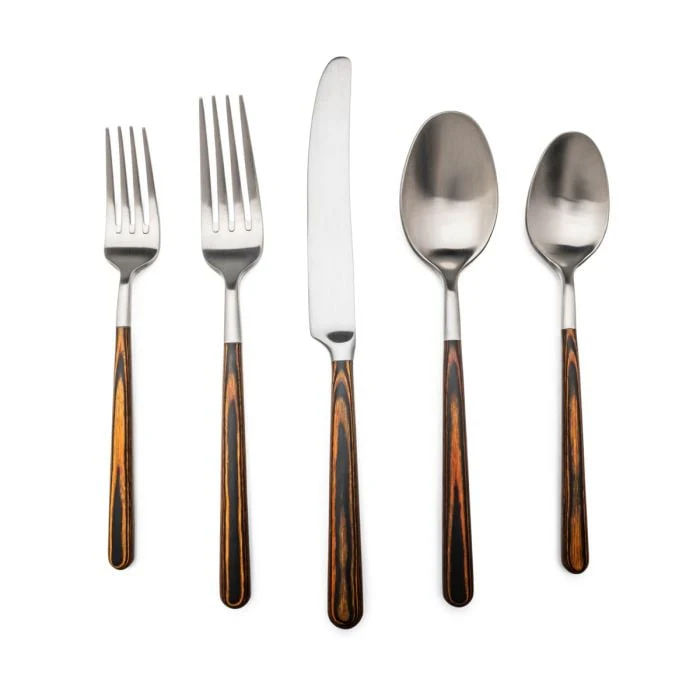 Five pieces from the Simon Pearce Hampton Hazel 5pps set—two forks, one knife, and two spoons—feature stainless steel heads and elegant resin handles, arranged in a row on a white background. This satin-finish flatware pairs beautifully with Hampton glassware for a refined dining experience.
