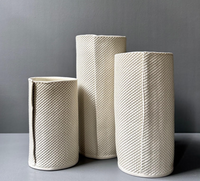 Three Pixel Cylinder Vase Cream porcelain vases in varying heights, each featuring a grid texture and a vertical seam.