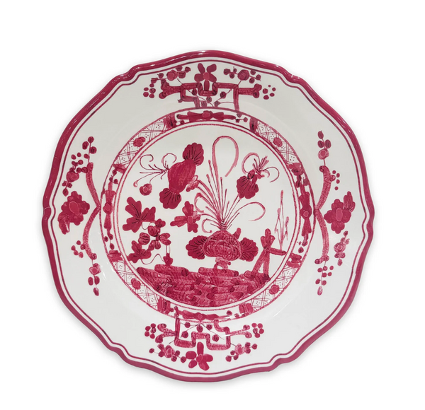 The Beatriz Ball Faenza Melamine Dinnerware Deep Pink - Set of 4 features a scalloped edge and intricate red floral and geometric designs on white, inspired by classic Italian ceramics.