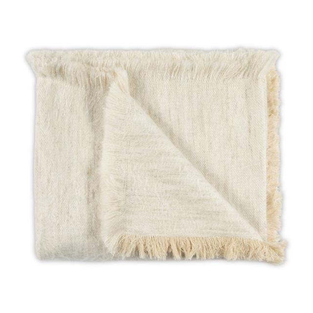 The Cosy Frayed Throw in Bisque by Moss Studio is a folded, handcrafted throw with fringed edges, displayed on a white background.