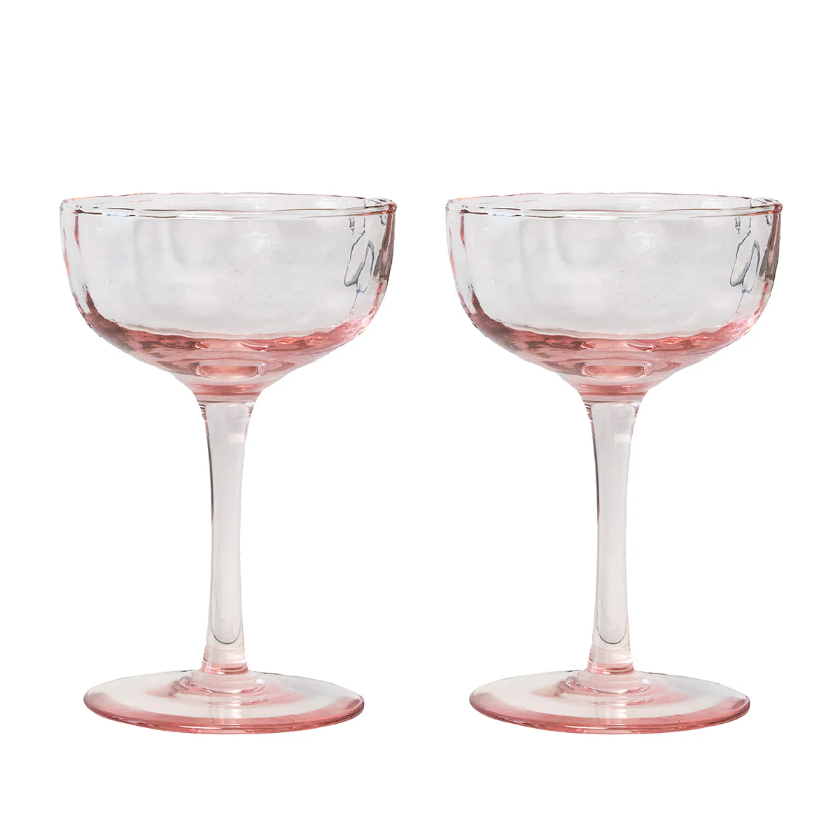 Two clear Puro Cocktail Coupe glasses by Juliska, featuring pink-tinted bases and stems, are placed side by side against a white background—perfect for serving cocktails. This elegant set of two comes beautifully gift boxed, making it an ideal present for any special occasion.