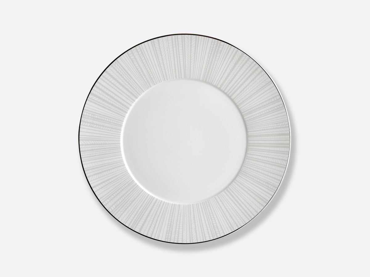 The Silva Dinnerware Serving Pieces by Bernardaud feature a white plate with a light gray sunburst pattern, adding sophisticated elegance to any table setting.