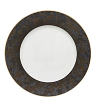 The Aguirre Dinnerware by Jaune De Chrome features a round ceramic plate with a wide, dark brown patterned rim and a plain white center, shown from above against a white background—an elegant piece that captures the timeless style of French dinnerware.