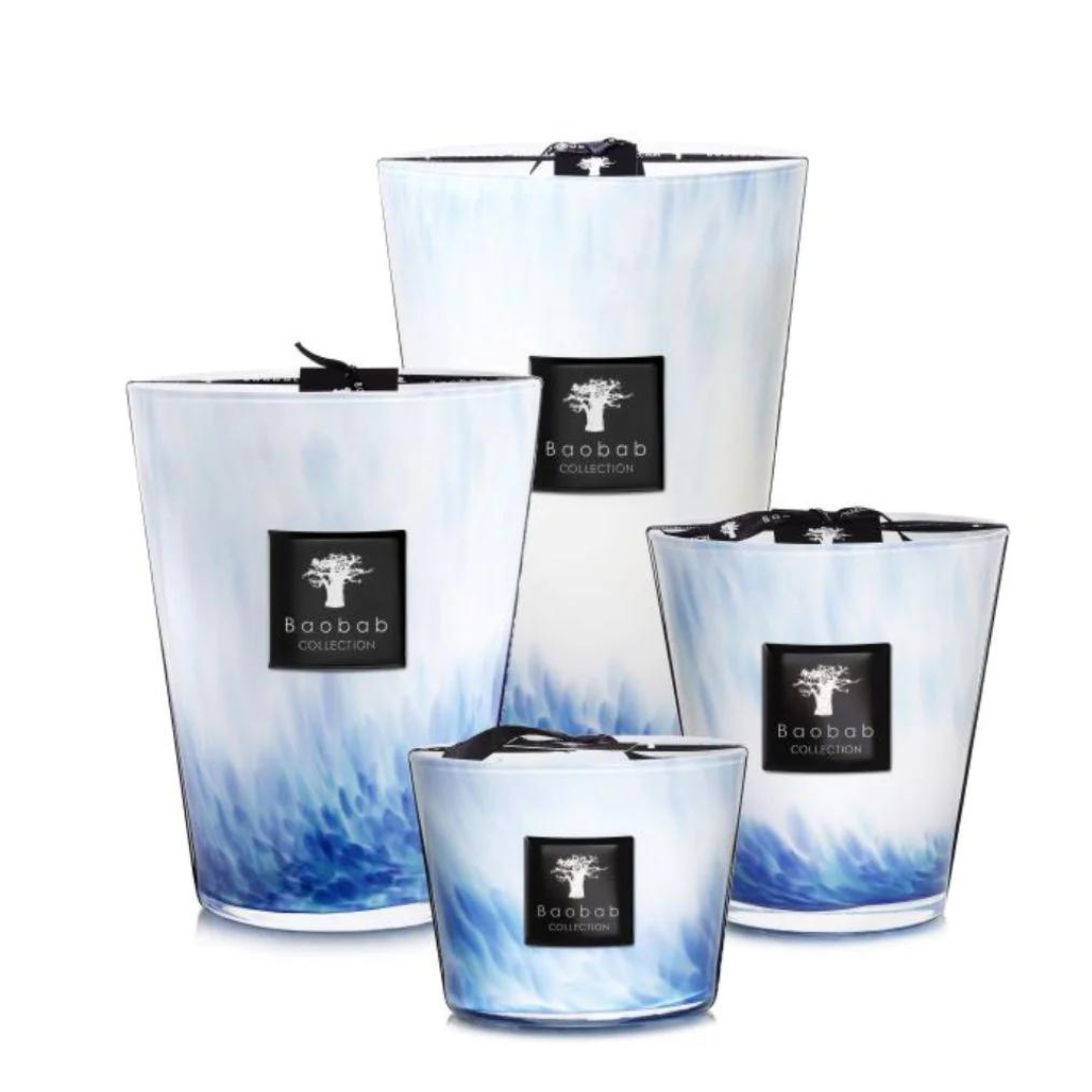 Baobab’s Eden Seaside Candles feature opalescent glass in elegant white and blue marble patterns, each adorned with a black label and ribbon, evoking the spirit of the South Seas.