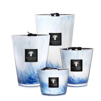 Baobab’s Eden Seaside Candles feature opalescent glass in elegant white and blue marble patterns, each adorned with a black label and ribbon, evoking the spirit of the South Seas.