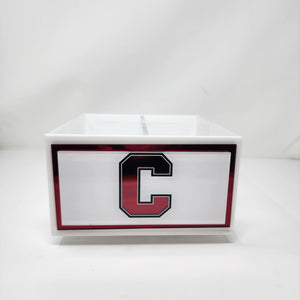 The Eye Candy College Spinner, a white rectangular organizer featuring a bold black and red letter C college logo, stands out on any desk and makes a stylish organization solution.