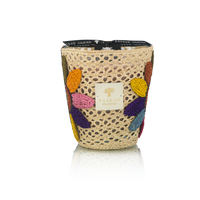 The Baobab Tournesol Girasol Candle features a decorative woven holder with colorful crocheted flower petals, a black ribbon, and the Baobab label for a vibrant touch to any home décor. Set against a white background.