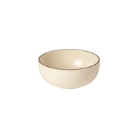 The Pacifica Dinnerware Monterosa Beige bowl by Casafina/Costa Nova features a slightly speckled beige ceramic surface with a dark rim, displayed against a white background.