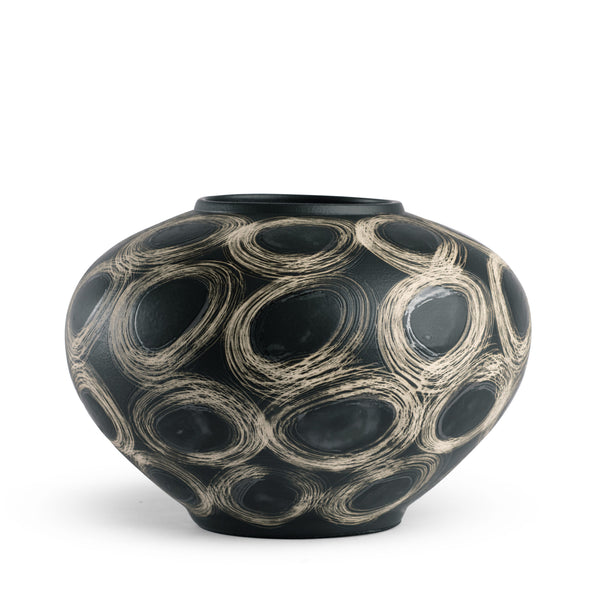 The Wren Vase - Black by FlowDecor Inc. is a round black ceramic vase with a narrow opening, featuring bold swirling cream circles—an eye-catching accent for any decor.