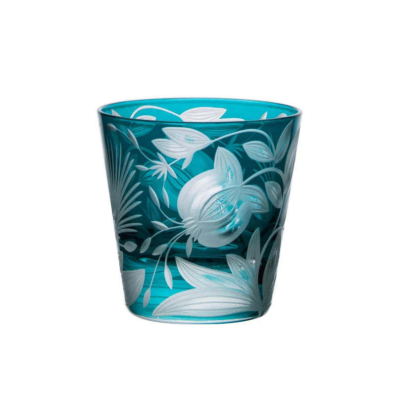 A teal Artel Verdure Vodka / Liqueur Glass - Jewel Tones - tumbler etched with a floral and leaf pattern.