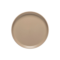 The Casafina/Costa Nova Pacifica Chestnut- plate is a round, plain, beige ceramic dish with a slightly raised rim, shown from above on a white background.