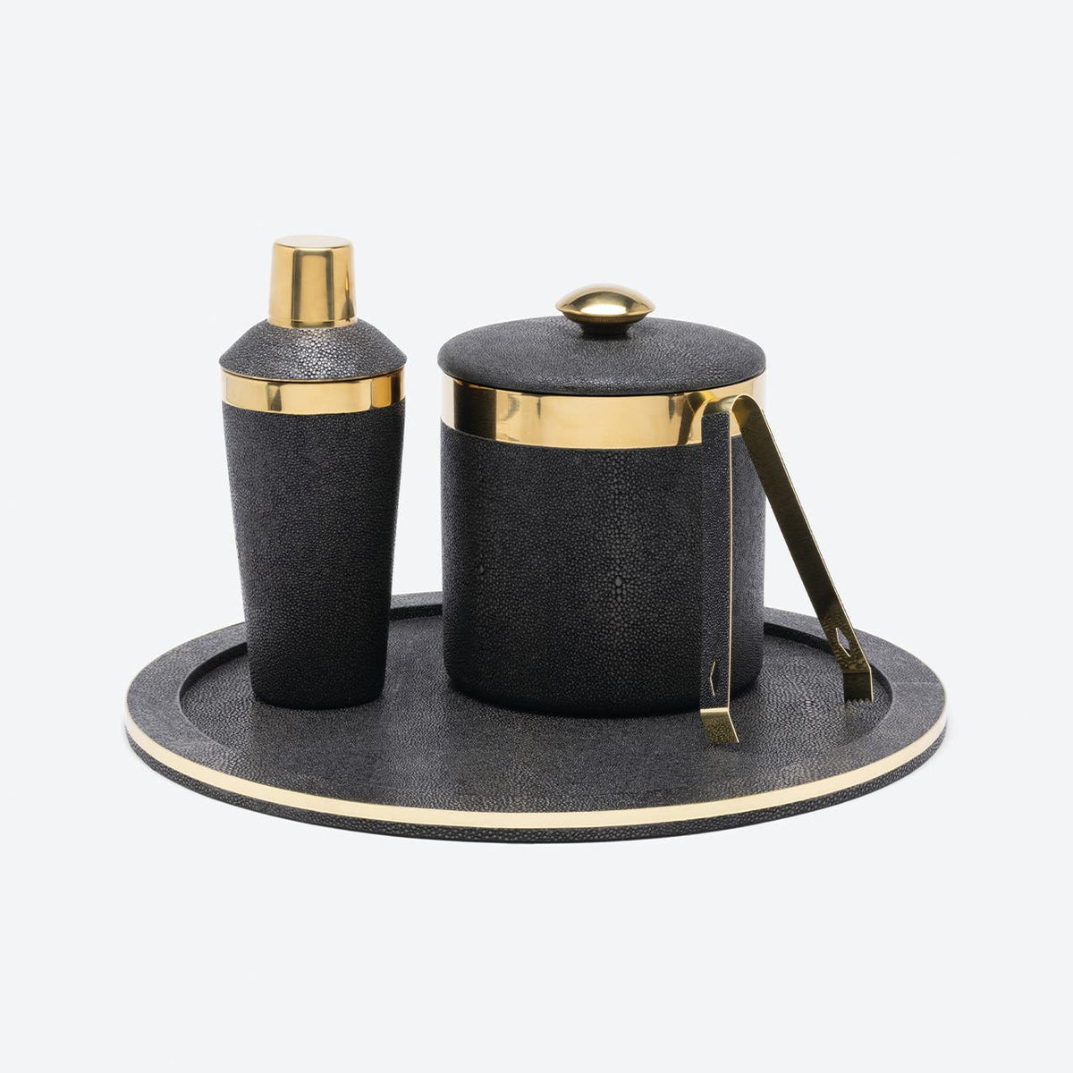 Dark Mushroom Langston Ice Bucket & Tongs with lid, cocktail shaker, and ice tongs on a matching round tray, all accented with gold-tone metal bar accessories.