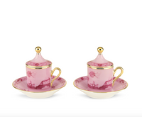 Two pink Ginori 1735 Oriente Italiano Porpora porcelain espresso cups with matching saucers, featuring chinoiserie floral and architectural patterns, gold handles, and gold-topped lids.