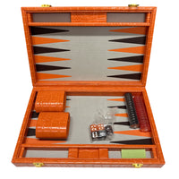 The Nile Travel Backgammon by Tizo is an open orange compact set with dice, doubling cube, red and black checkers, dice cups, and a gray/orange geometric playing surface.