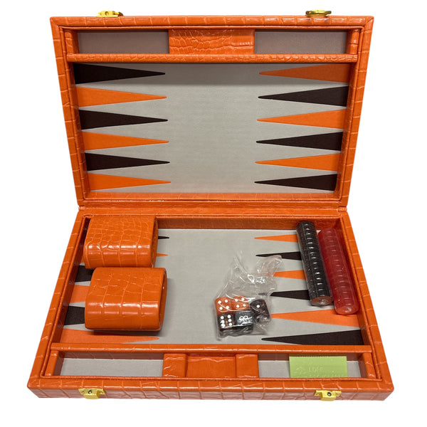 The Nile Travel Backgammon by Tizo is an open orange compact set with dice, doubling cube, red and black checkers, dice cups, and a gray/orange geometric playing surface.